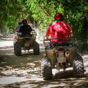 Group riding ATVs through tropical jungle trails during a Cozumel ATV tour in Mexico