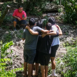 Friends taking photos during a Cozumel ATV tour near jungle trails and Mayan cenotes in Mexico