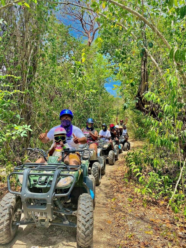 Family enjoying a guided ATV tour through jungle trails in Cozumel Mexico